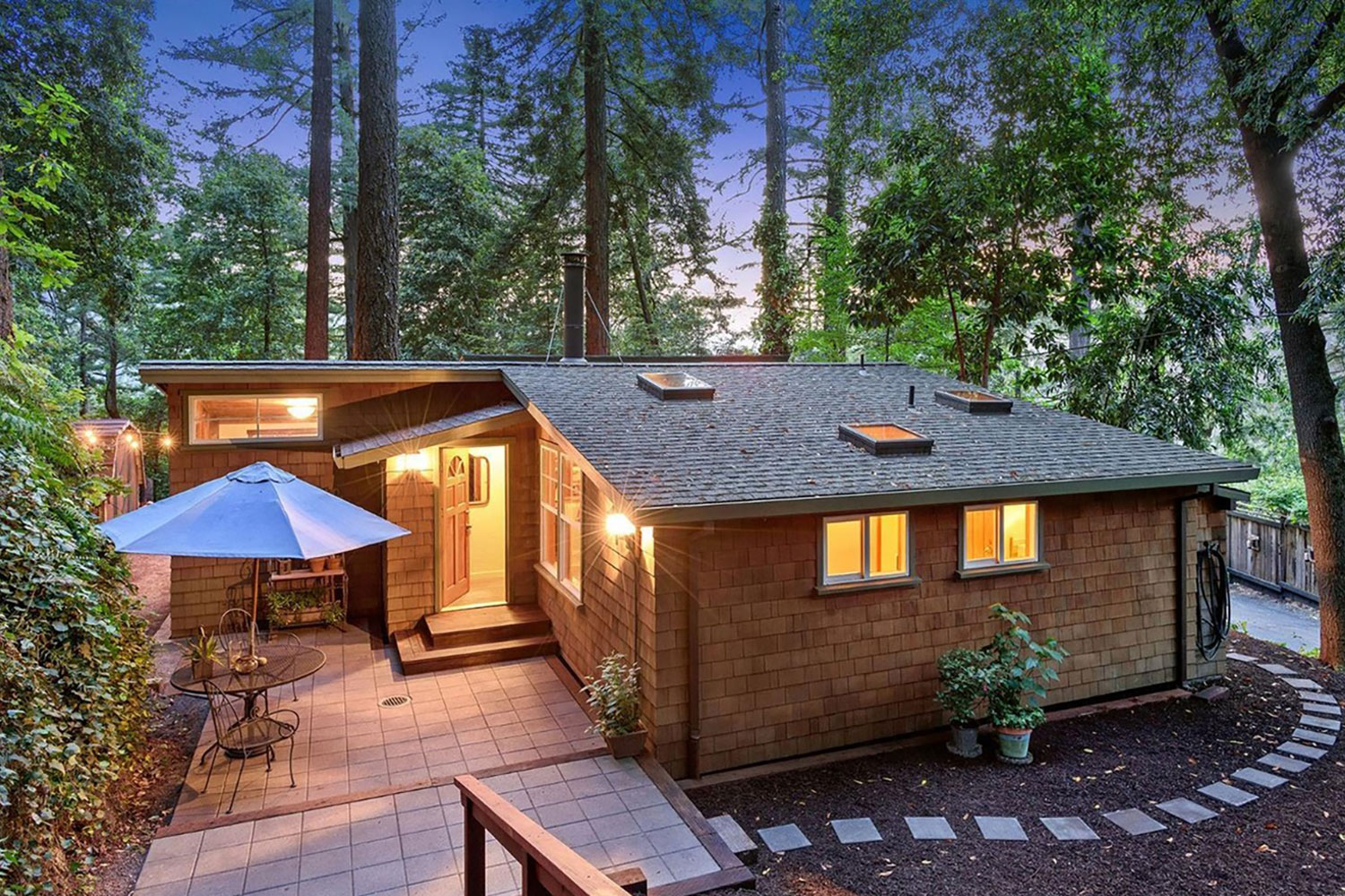 Russian River vacation home set amongst Redwood trees. Cabin style house with cedar trim. Landscaped garden and patio.